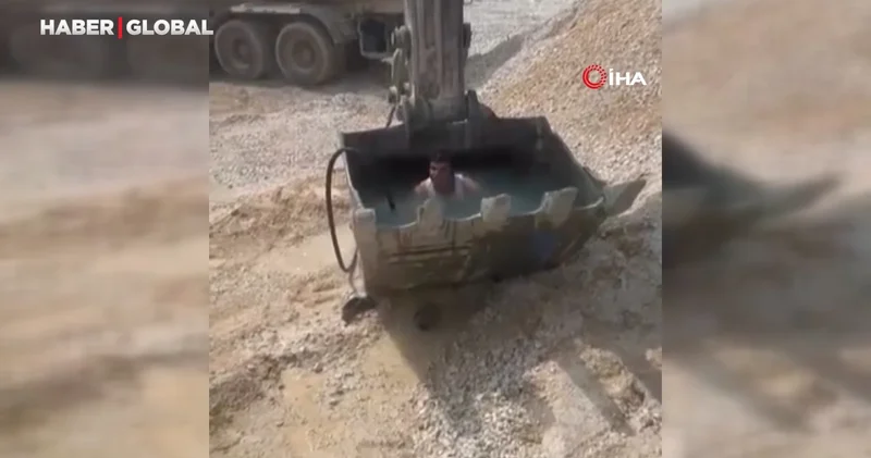 Sıcaktan bunalan işçiler kepçeyi havuza çevirdi