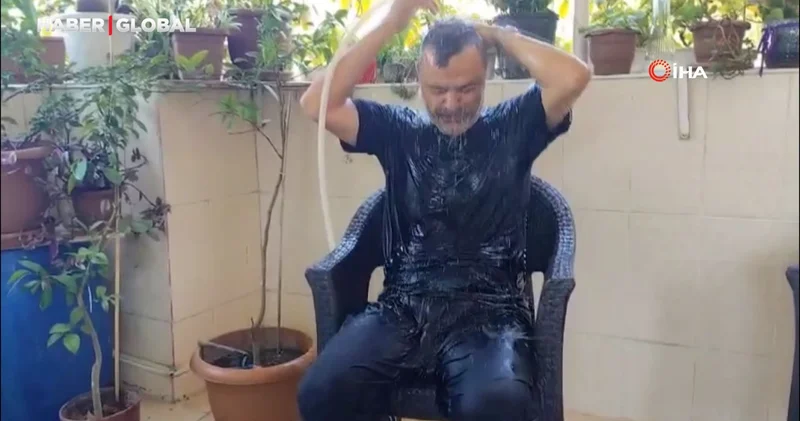 Fatih’te sıcaktan bunaldı, hortumla serinlemeye çalıştı