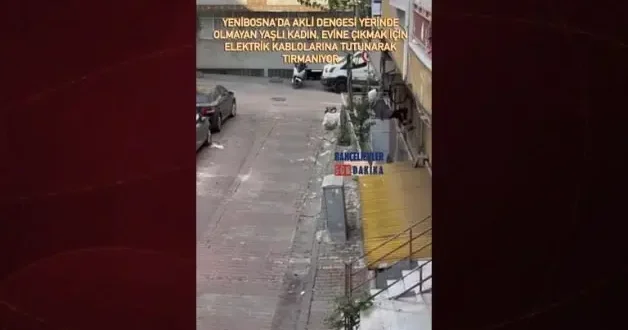 Akli dengesi yerinde olmayan yaşlı bir kadın, evine çıkmak için elektrik kablolarına tırmanıyor